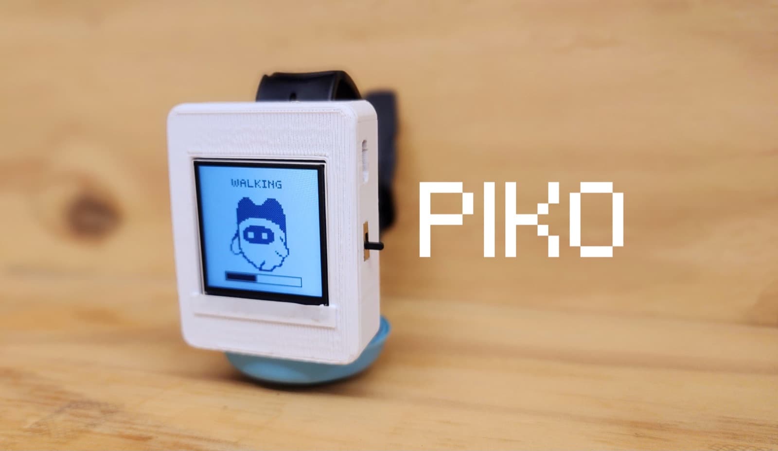 PIKO wearable companion with a tiny screen showing a walking character